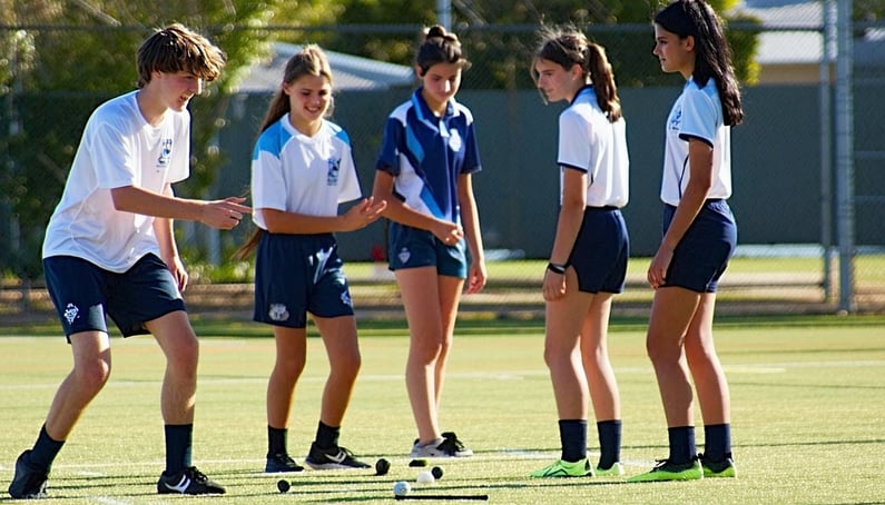 A group of Australian high school students aged 1718 playing sport in PE class they are in teams and one person has to show they are making sacrifices they are all dress in their sport uniform-1